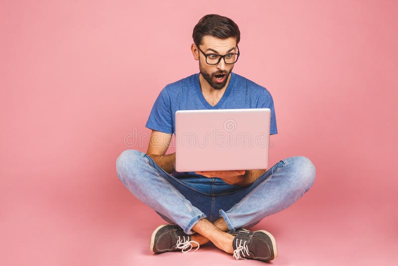 Online working concept. Casual business man relaxed working and browsing internet on laptop computer. Freelance sitting and typing