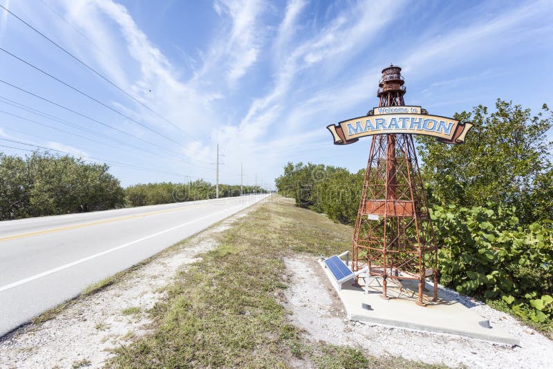 Marathon Key, Fl, USA - March 16, 2017: Welcome to Marathon Key sign on a lighthouse at the road side. Florida, United States. Marathon Key, Fl, USA - March 16, 2017: Welcome to Marathon Key sign on a lighthouse at the road side. Florida, United States