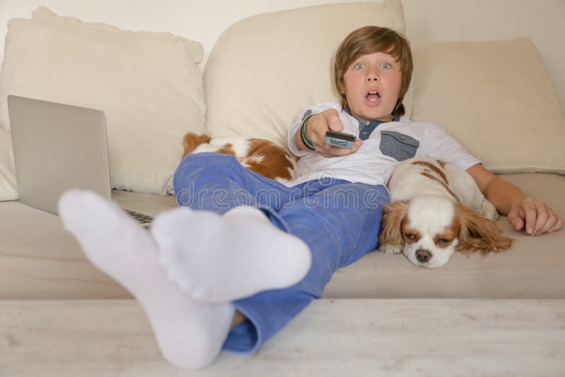 Smiling happy boy watching TV. Smiling happy boy watching TV