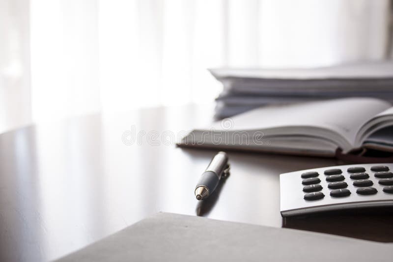 Planner with pen and calculator on the table. Planner with pen and calculator on the table