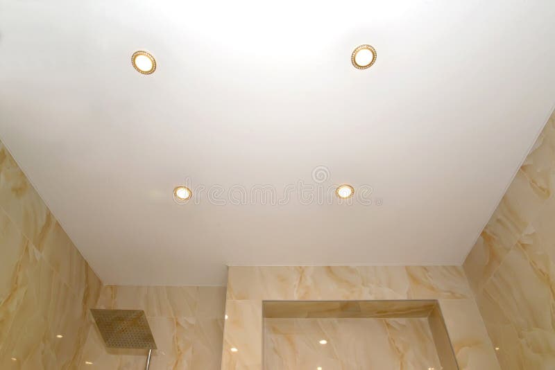 Opaque Stretch Ceiling with Dot Lamps in the Bathroom Stock Photo