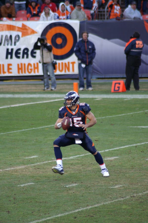 Denver bronco's quarteback Tim Tebow with ball in right hand prepares to pitch ball off during option play against chiefs. Tebow and the broncos are playing in the nfl playoffs. Denver bronco's quarteback Tim Tebow with ball in right hand prepares to pitch ball off during option play against chiefs. Tebow and the broncos are playing in the nfl playoffs