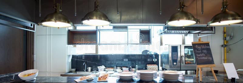 Open area kitchen for breakfast. Dishes and food samples were placed on the counter. Food list on black board : Fried egg royalty free stock photo