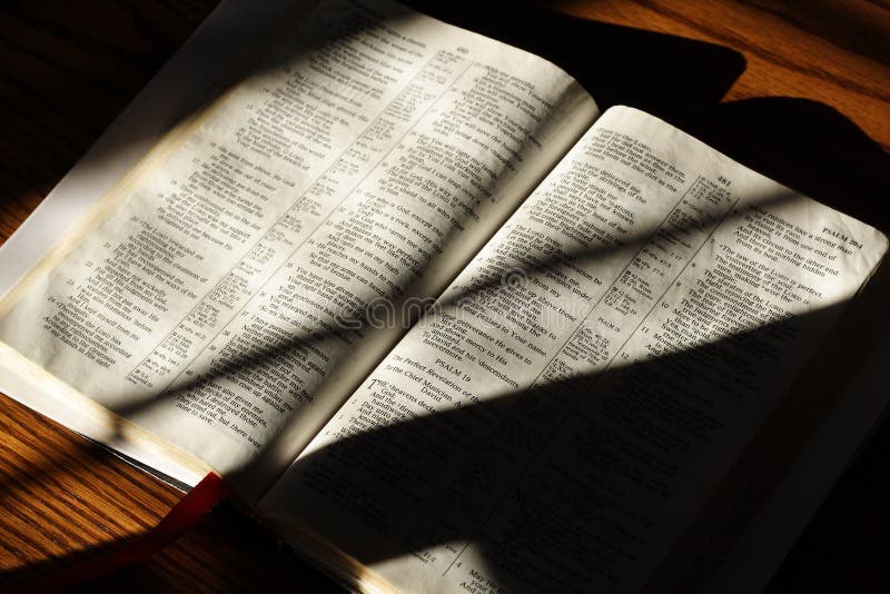 Bible open to the Psalms laying on a table for reading or study. Bible open to the Psalms laying on a table for reading or study