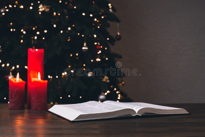 An Open Bible on the Table. Prayer. Christmas Background. Candles