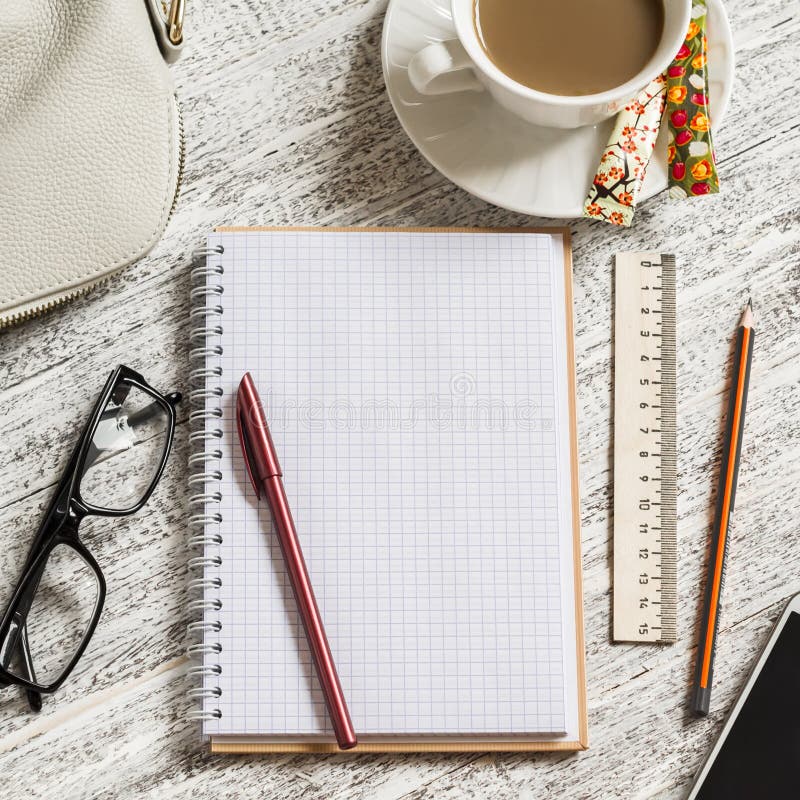 Open a blank white notebook, pen, women's bag, ruler, pencil and cup of coffee stock photo Open a blank white notebook, pen, women's bag, ruler, pencil and cup of coffee stock photo