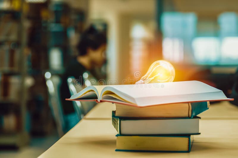 Open book on stack of books in library at school, university, college stock photography