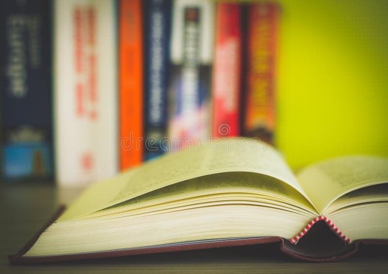 Open book, stack of colorful hardback books isolated on white background. Back to school. Copy space for text. Toned image