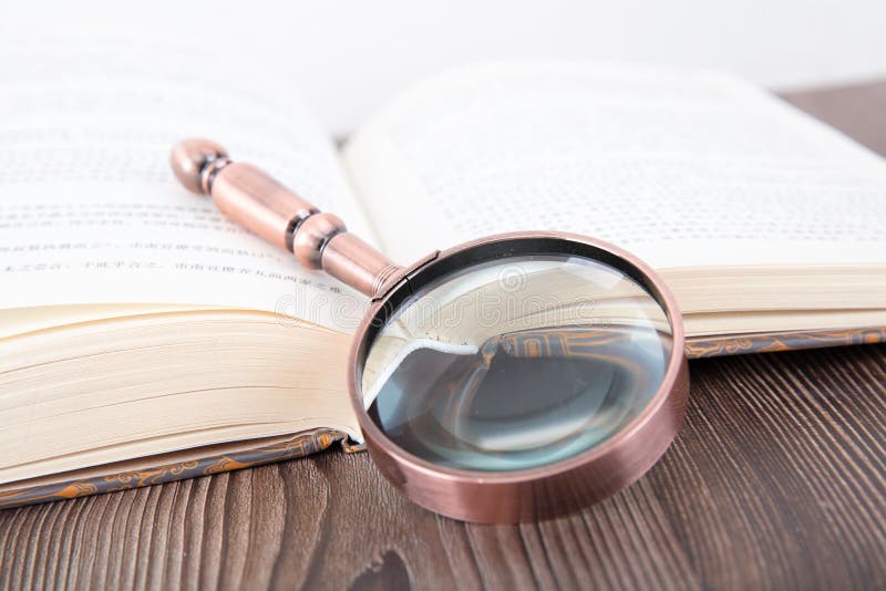Open Books and Magnifying Glass Stock Photo Image of media, book