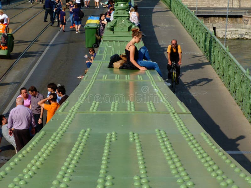 Open Bridge Day on the Liberty bridge in Budapest with people sitting on the girders