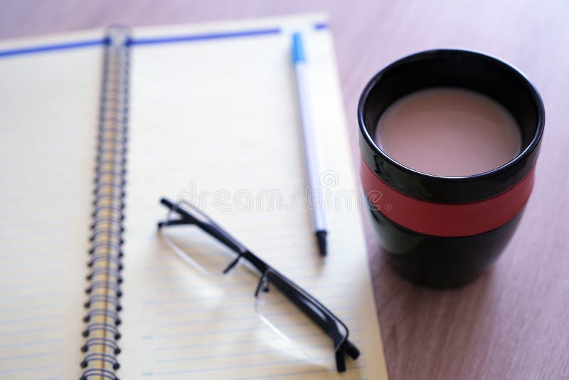 Open the diary a planner, a pencil and glasses on the table closeup royalty free stock photos