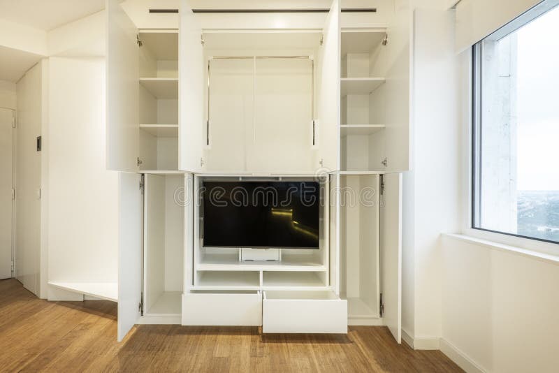 Open Dining Room Bookcase Design with Shelves, Drawers Stock Photo