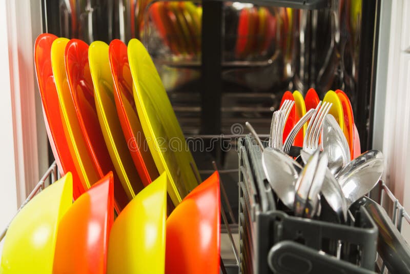Open dishwasher with fresh clean dish and flatware royalty free stock photo