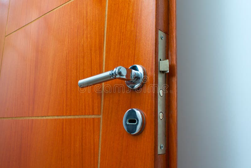 Open door of a family home. Close-up of the lock an armored door. White background.