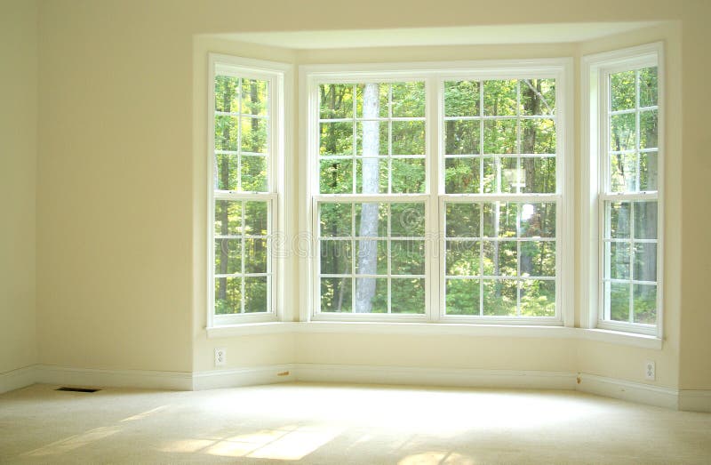 Bright and airy room inside a home with bay window to let sunlight in. Bright and airy room inside a home with bay window to let sunlight in