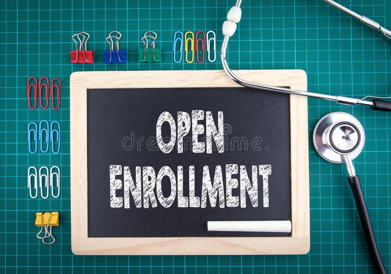 Open Enrollment concept. Medical and health background. Work desk with stationery and stethoscope