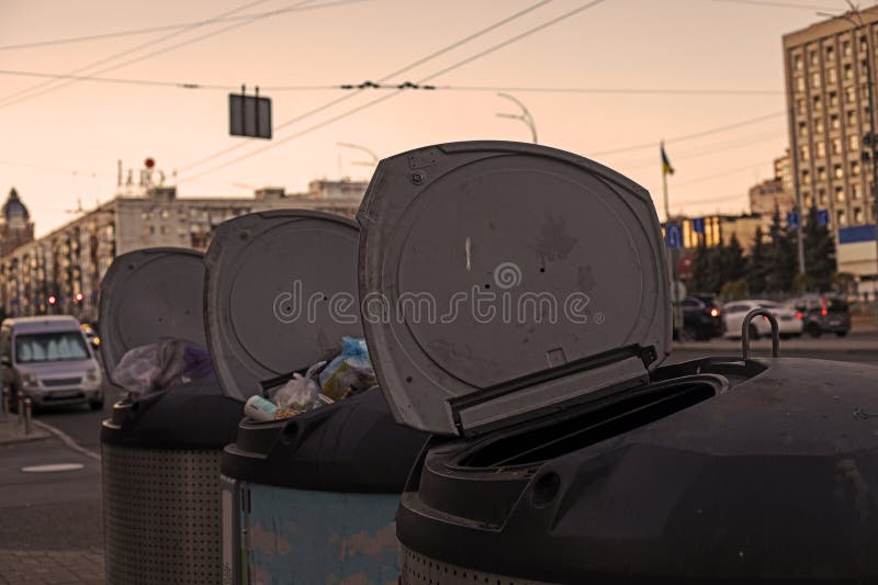 Open Garbage Cans with Plastic Bags with Garbage in the City Near the