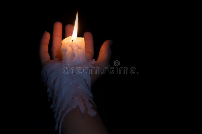 Open Hand Holding Candle Stick with Wax Flowing Down the Arm Stock
