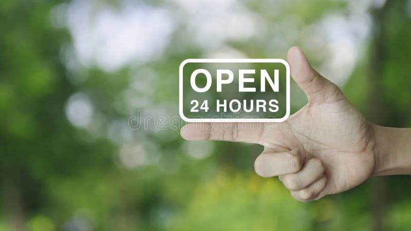 Open 24 hours icon on finger over blur green tree in park, Business full time service concept stock footage