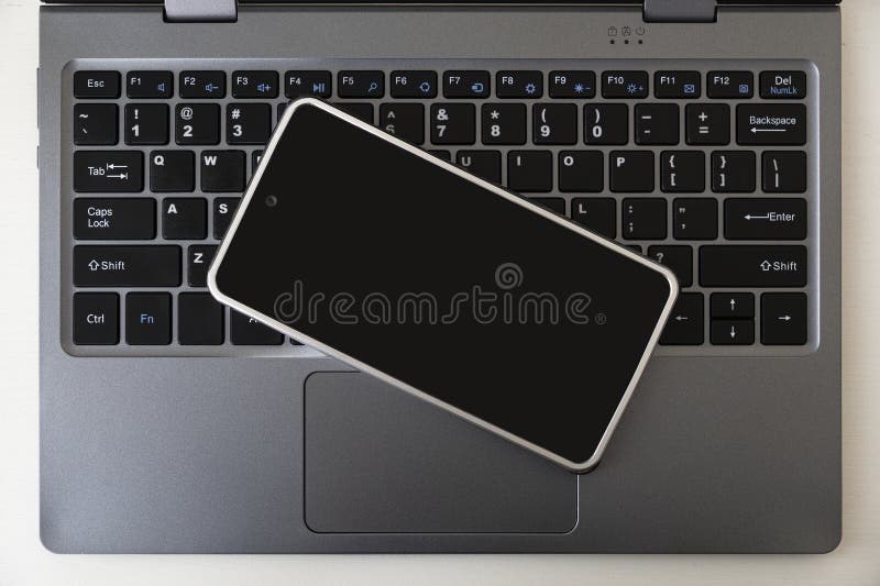 Open Laptop with Black Screen Smartphone. Copy Space. Top View Stock