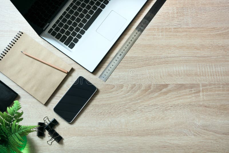 Open laptop and messthetics objects on office wooden desk table. Top view.