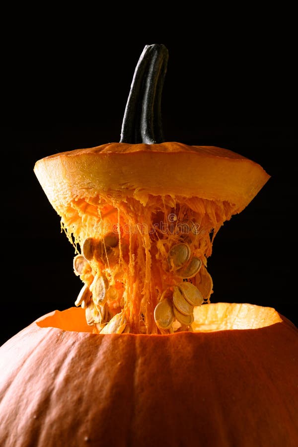 Open large orange pumpkin on black background stock photo