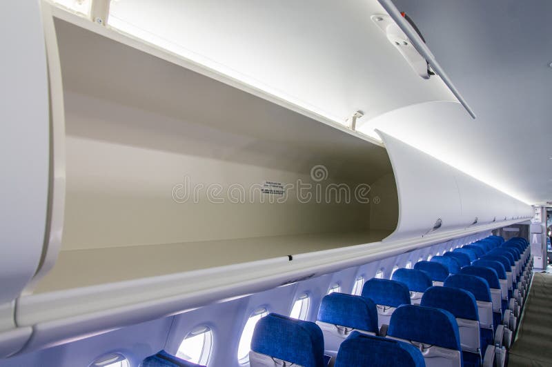 Open Luggage Rack and Interior View of the Passenger Airplane Stock