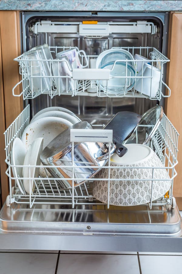 Open Modern Dishwasher with Messy Dishes in the Kitchen Stock Photo