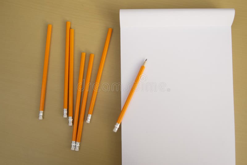 Open notebook blank paper with pencils on wooden background. Copy space. royalty free stock photos