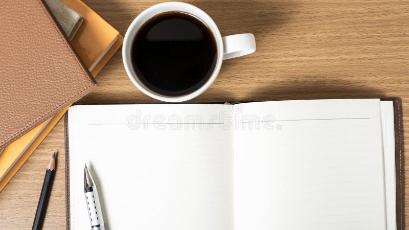 Open notebook with book and coffee cup