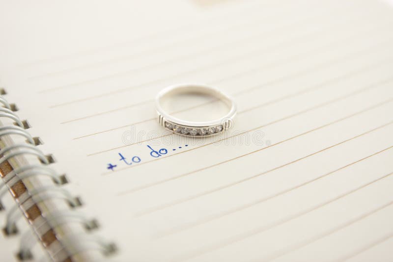 Open notebook and diamond ring...love concept