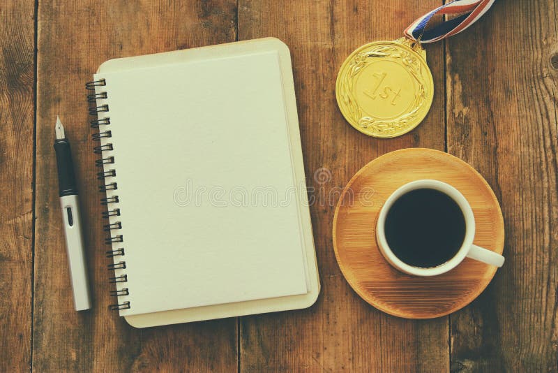 Open notebook with empty pages and other office supplies over wooden old office desk table. Top view, flat lay royalty free stock images Open notebook with empty pages and other office supplies over wooden old office desk table. Top view, flat lay royalty free stock images
