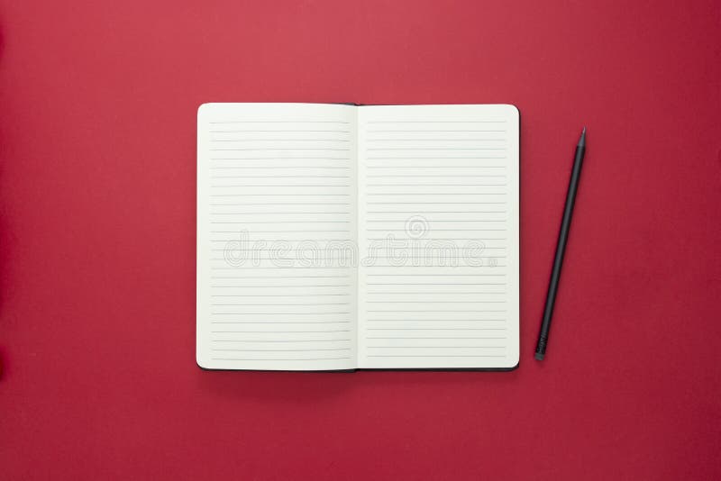 Open notebook isolated on red background, copy space for text stock photos