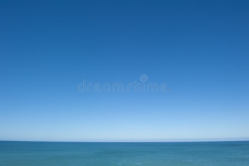 Open Ocean View. A view over tranquil flat water of the Indian Ocean to the horizon, with a spotless clean blue sky as background and copy space royalty free stock photos Open Ocean View. A view over tranquil flat water of the Indian Ocean to the horizon, with a spotless clean blue sky as background and copy space royalty free stock photos