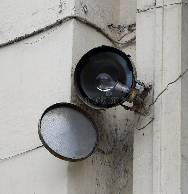 An Open Old Singlelamp Spotlight on the Wall of the House Stock Photo
