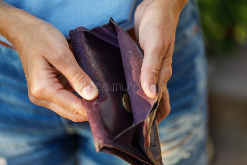 Open purse with coins inside as a sign of lack of money