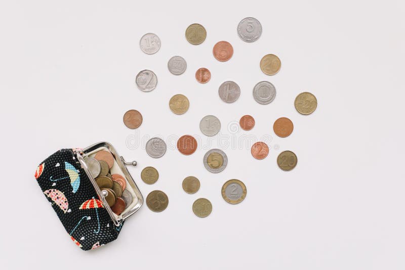 Open purse with different coins isolated on white background top view. Financial crisis, poverty, lack of money. Open purse with different coins isolated on white background top view. Financial crisis, poverty, lack of money