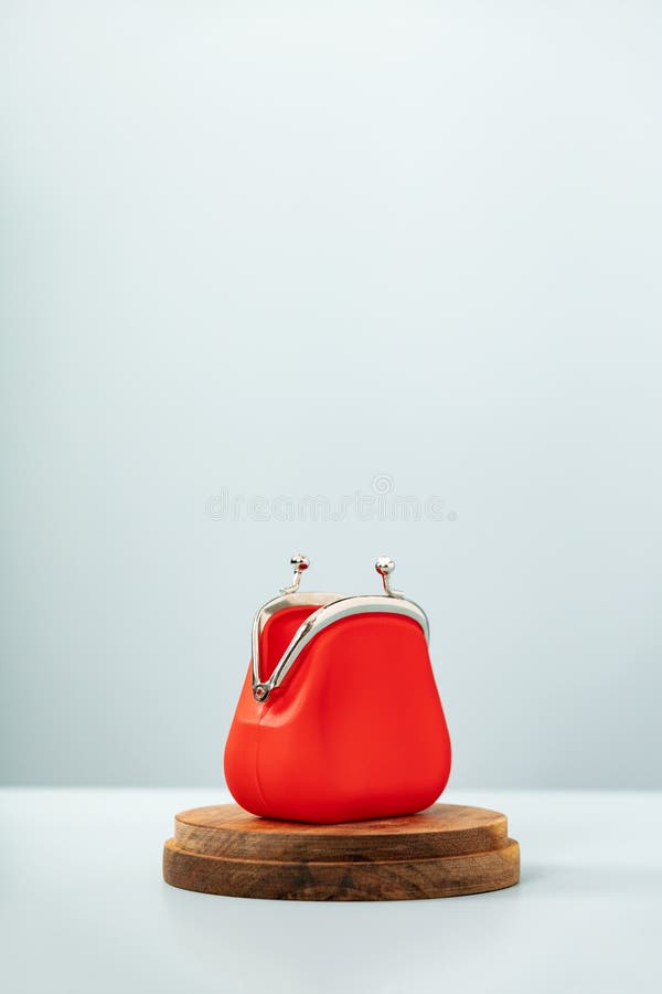 Open Red Coin Purse on wooden podium on blue background stock images