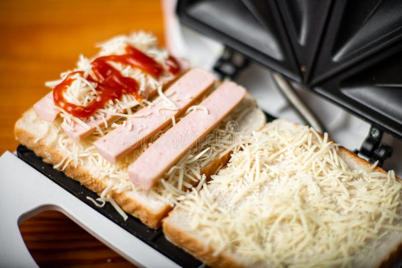 Open Sandwich Maker with Cheese Toast and Sausages. Sandwiching Stock