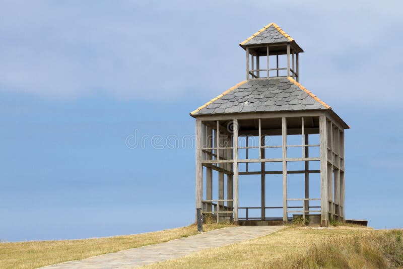 Open sided Hut in a Field with Dense Greenery Under the Thin Clouds Open sided Hut in a Field with Dense Greenery Under the Thin Clouds