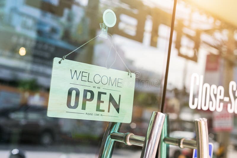Open sign broad through the glass of window at coffee shop. stock photo Open sign broad through the glass of window at coffee shop. stock photo