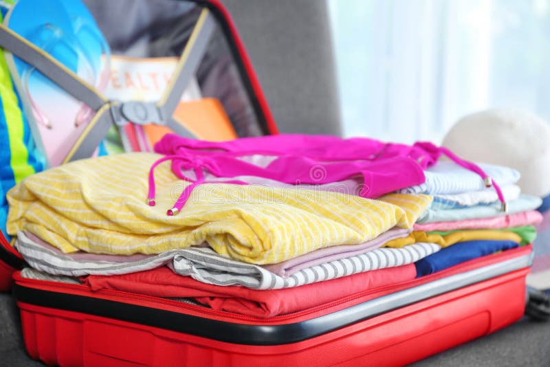 Suitcase with Different Clothes and Accessories, Closeup. Packing for Vacation Stock Image