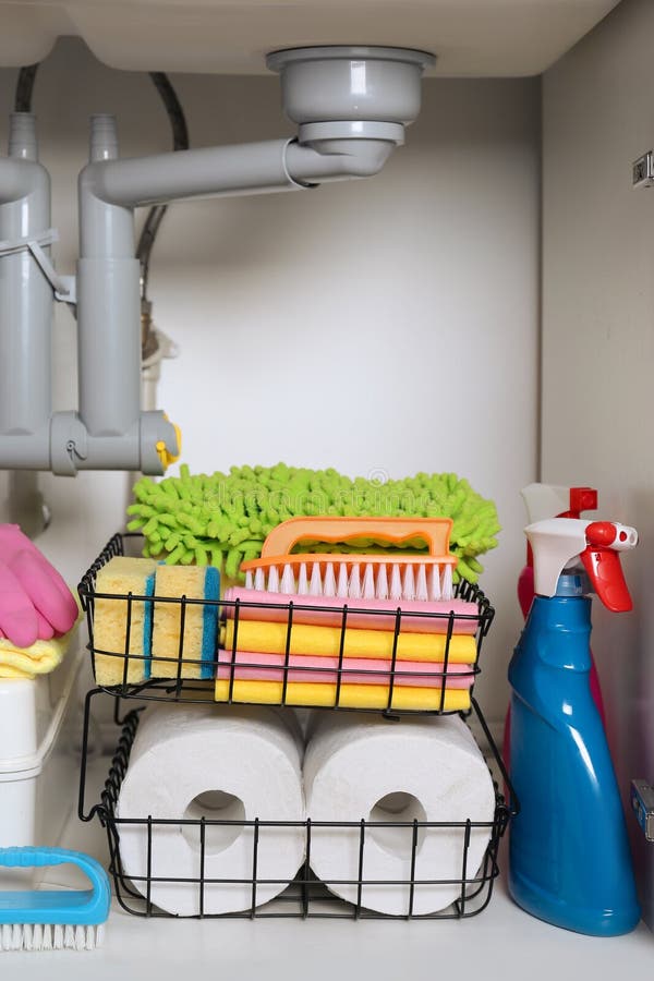 Open Under Sink with Different Cleaning Supplies in Kitchen