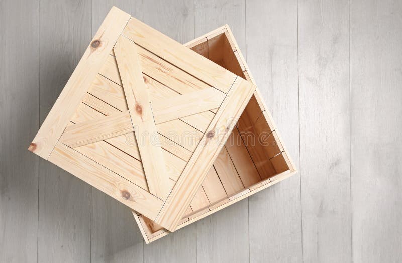 Open wooden crate on floor, top