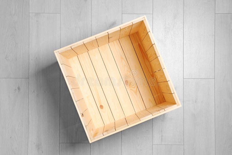 Open wooden crate on floor, top