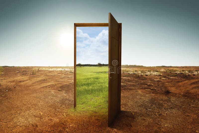 Open wooden door to the new world with green environment