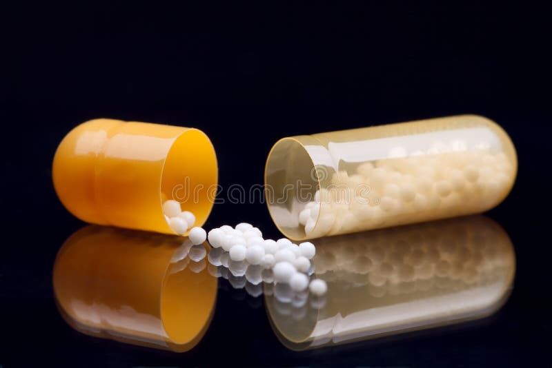 Open Yellow and White Pill (capsule) Macro Shot, on Bla Stock Image