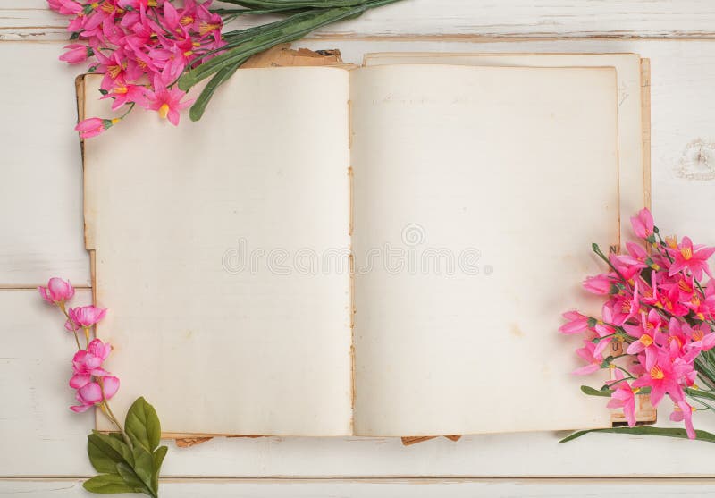 Opened and Blank Vintage Journal Paper or Stationary Book with Pink Feminine Flowers on Shabby Chic White Board Table Background.