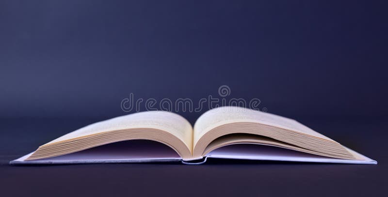 Opened book on blank table stock photography Opened book on blank table stock photography