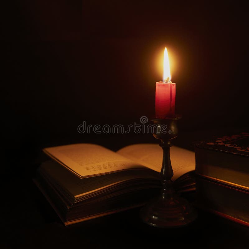 Opened Book with German Text Illuminated by a Short Candle in a Stand